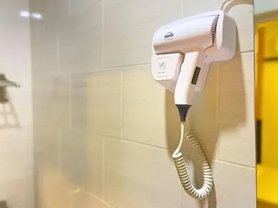 a phone is hanging on a wall in a bathroom at Seeds Hotel Chow Kit in Kuala Lumpur