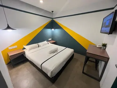a bedroom with a bed with a colorful wall at Seeds Hotel Chow Kit in Kuala Lumpur