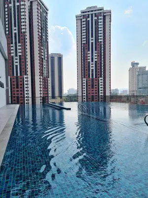 a swimming pool in a city with tall buildings at Kualalampur Chambers KLCC By Sky Pool in Kuala Lumpur