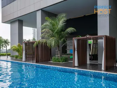 a pool in front of a building with a hotel at Pavilion Ceylon Hill Suites, Bukit Bintang by Perfect Host in Kuala Lumpur