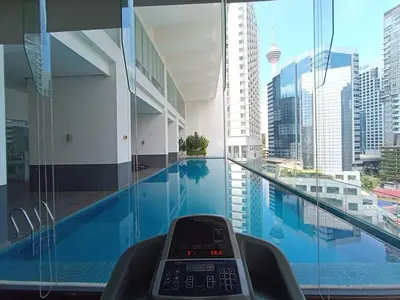 a swimming pool in a building with a view of a city at RM203A Bukit Bintang Balcony Studio Infinity Pool in Kuala Lumpur