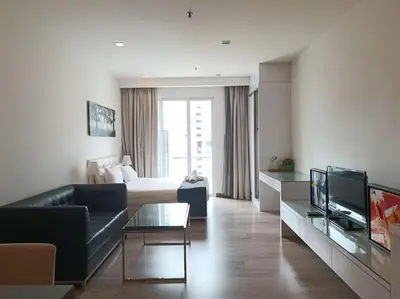 a living room with a couch and a bed at RM203A Bukit Bintang Balcony Studio Infinity Pool in Kuala Lumpur