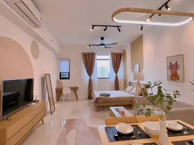 a living room with a couch and a tv at Cozy & Homely Chambers KL@3 Mins Walking Distance to LRT & Monorail in Kuala Lumpur