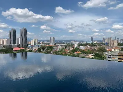 a large body of water with a city in the background at Infinity pool! High Speed WiFi! Rica Residence! in Kuala Lumpur