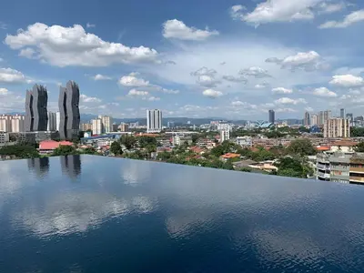a large body of water with a city in the background at Infinity pool! High Speed WiFi! Rica Residence! in Kuala Lumpur