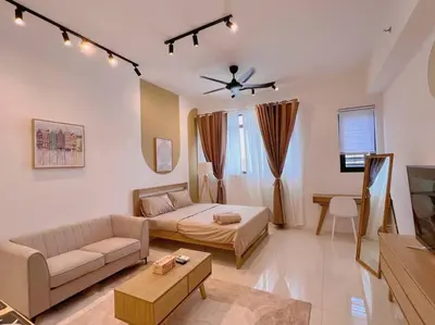 a living room with a couch and a table at Comfy & Cozy Chambers KL, Near PWTC & Sunway Putra Mall in Kuala Lumpur