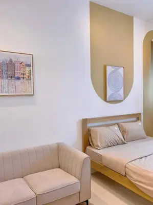 a room with a bed and a couch and a mirror at Comfy & Cozy Chambers KL, Near PWTC & Sunway Putra Mall in Kuala Lumpur