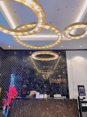 a room with a chandelier and a poster on the wall at Comfy & Cozy Chambers KL, Near PWTC & Sunway Putra Mall in Kuala Lumpur