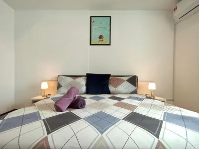 a bedroom with a large bed with purple pillows at BBHomes at Bukit Bintang Casa Residency KL in Kuala Lumpur