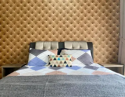 a bedroom with a bed with a quilt and pillows at BBHomes at Continew Residensi Pudu KL digitalife in Kuala Lumpur