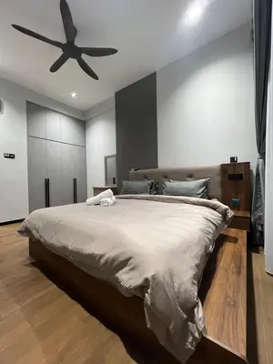 a bedroom with a large bed with a ceiling fan at Opus Residences 1 Bedroom Apartment in Kuala Lumpur