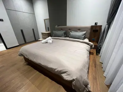 a bedroom with a large bed with two towels on it at Opus Residences 1 Bedroom Apartment in Kuala Lumpur