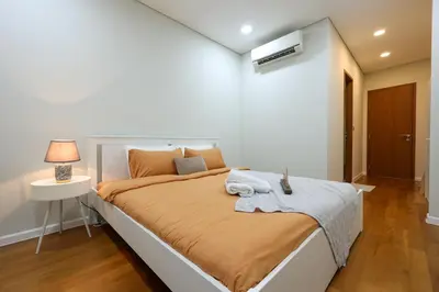 a bedroom with a large bed in a room at Sky Suites KLCC By Calm Sojourn in Kuala Lumpur
