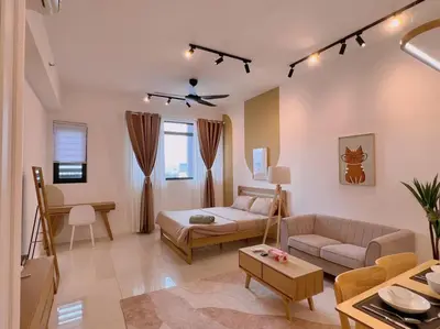 a living room with a couch and a table at Spacious Connecting Room 4px, Chambers Residence KL, Walking Distance to LRT, MRT, Sunway Putra Mall & PWTC in Kuala Lumpur