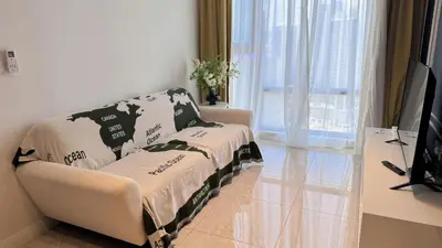 a living room with a couch and a television at The Ress - The Axon Bukit Bintang Residence in Kuala Lumpur
