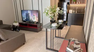 a living room with a couch and a television at The Ress - The Axon Bukit Bintang Residence in Kuala Lumpur