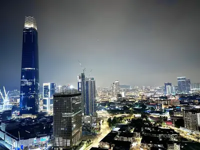 a city skyline with skyscrapers in a city at night at Axon Suites Bukit Bintang by Prestige in Kuala Lumpur