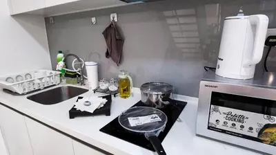 a small kitchen with a stove and a sink at EkoCheras Loft 5 pax, #SoccerTable #AboveMall #Cozy #FreeCarPark in Kuala Lumpur