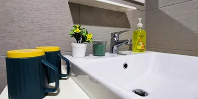 a sink with two cups on top of it at EkoCheras Loft 5 pax, #SoccerTable #AboveMall #Cozy #FreeCarPark in Kuala Lumpur