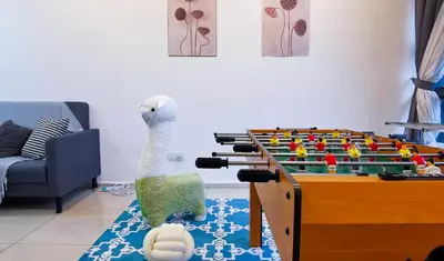 a living room with a large table with foos ball at EkoCheras Loft 5 pax, #SoccerTable #AboveMall #Cozy #FreeCarPark in Kuala Lumpur