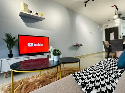 a living room with a tv and a table at MVD15#Family Suite 8pax 3 Rooms Sunway Velocity Mall Cheras IKEA Mytown Short Walk to MRT & LRT Maluri in Kuala Lumpur