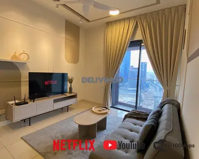 a living room with a couch and a tv at Continew at 35 floor - 5pax - KL - TRX - 2 Bedroom in Kuala Lumpur