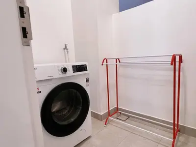 a laundry room with a washing machine in a room at Ample 2BR 4px Seputeh @ Near MidValley & Garden Mall, Old Klang Road in Kuala Lumpur