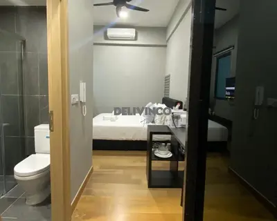 a bathroom with a toilet and a bed in a room at The Luxe 2 pax Studio at KL - Microwave - Washer in Kuala Lumpur