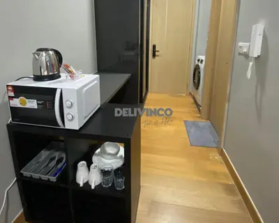 a room with a microwave on a counter and a hallway at The Luxe 2 pax Studio at KL - Microwave - Washer in Kuala Lumpur