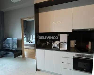 a kitchen with white cabinets and a black counter top at The Luxe - KLCC View - 3 pax Balcony at 41 floor in Kuala Lumpur