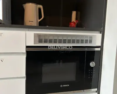 a black and white microwave oven in a kitchen at The Luxe - KLCC View - 3 pax Balcony at 41 floor in Kuala Lumpur