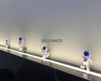 a shelf with astronaut figurines on it at Stylish AeroSpace Theme 1BR in KL City Center in Kuala Lumpur
