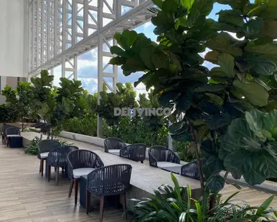 a row of chairs and tables in a building at The Luxe - Balcony at 42 floor - KLCC View - 3 pax in Kuala Lumpur