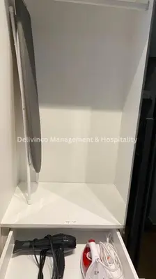 a white cabinet with a computer monitor and cables at The Luxe Studio - 2 pax - KL - Microwave - Fridge in Kuala Lumpur