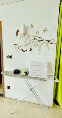 a table with towels and birds on a wall at Vortex suites klcc by Yashrib in Kuala Lumpur