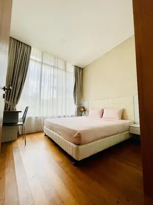 a bedroom with a large bed with pink pillows at Vortex suites klcc by Yashrib in Kuala Lumpur
