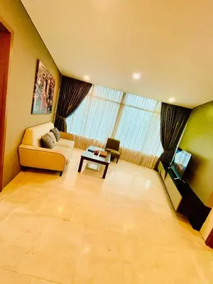 a large living room with a couch and a table at Vortex suites klcc by Yashrib in Kuala Lumpur