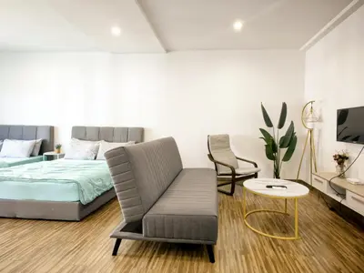 a bedroom with a bed and a couch and a chair at Setapak Central Mall KL - Zetapark Garden Suites in Kuala Lumpur