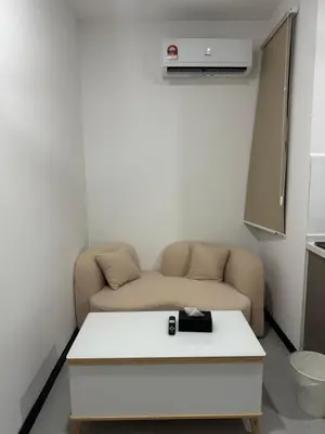 a living room with a couch and a table at Neu Suites @ 3rdNvenue 003 in Kuala Lumpur