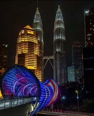 a light sculpture in front of the petronas towers at night at Luxurious Ceylonz Suite near Bukit Bintang 4pax in Kuala Lumpur