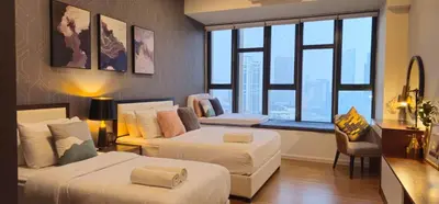 a hotel room with two beds and a large window at Luxurious Ceylonz Suite near Bukit Bintang 4pax in Kuala Lumpur