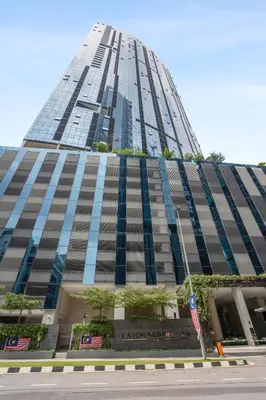 a tall building with a flag in front of it at Eaton Residences by Sutera at KLCC in Kuala Lumpur