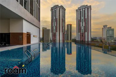 a pool on the roof of a building with two tall buildings at Chambers Residence, Sunway Putra Mall in Kuala Lumpur