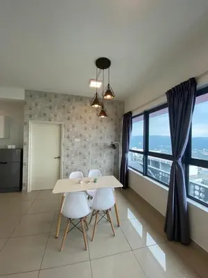 a dining room with a table and chairs and windows at Arte plus by sweet home 2BR in Kuala Lumpur