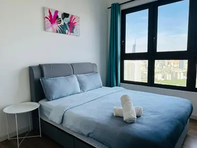 a teddy bear sitting on a bed in a bedroom at 4BR M Vertica near Sunway Velocity Cheras IKEA MRT TRX KLCC Pavilion in Kuala Lumpur