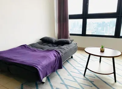 a living room with a couch and a table at 4BR M Vertica near Sunway Velocity Cheras IKEA MRT TRX KLCC Pavilion in Kuala Lumpur