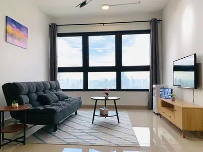 a living room with a couch and a large window at 4BR M Vertica near Sunway Velocity Cheras IKEA MRT TRX KLCC Pavilion in Kuala Lumpur