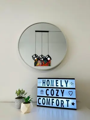 a mirror on a wall with a sign and a clock at 4BR M Vertica near Sunway Velocity Cheras IKEA MRT TRX KLCC Pavilion in Kuala Lumpur