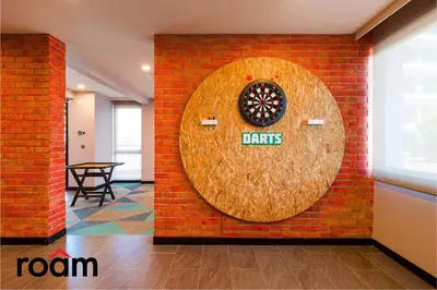 a wall with a dart board on a brick wall at Datum Jelatek Sky Residence Kuala Lumpur, Roam in Kuala Lumpur