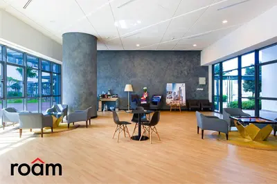 an office lobby with chairs and tables and windows at Datum Jelatek Sky Residence Kuala Lumpur, Roam in Kuala Lumpur